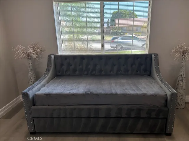 a living room with a bed and a window