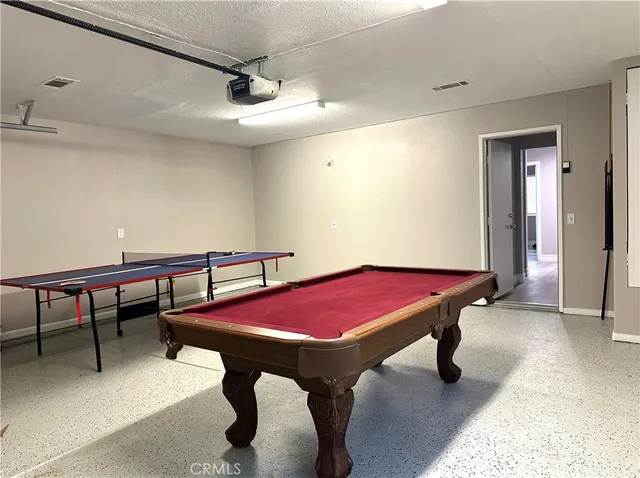 a room with furniture and pool table
