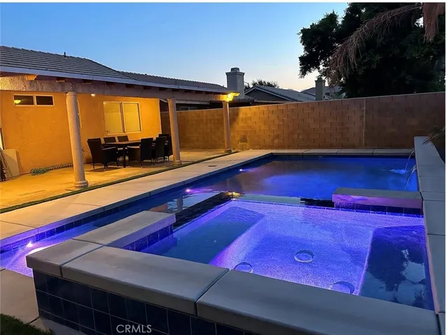 a swimming pool with red umbrella