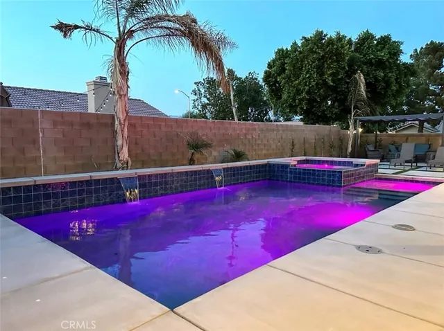 swimming pool view with a seating space