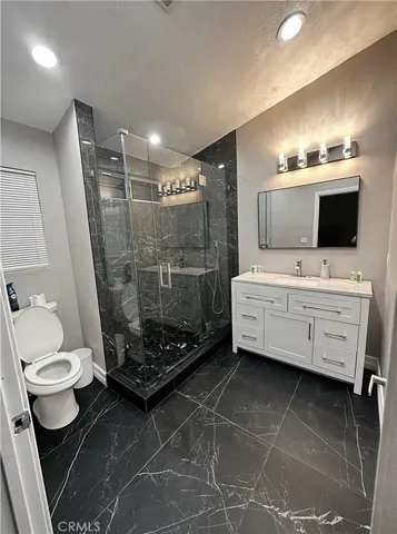 a large bed sitting in a bedroom next to a window