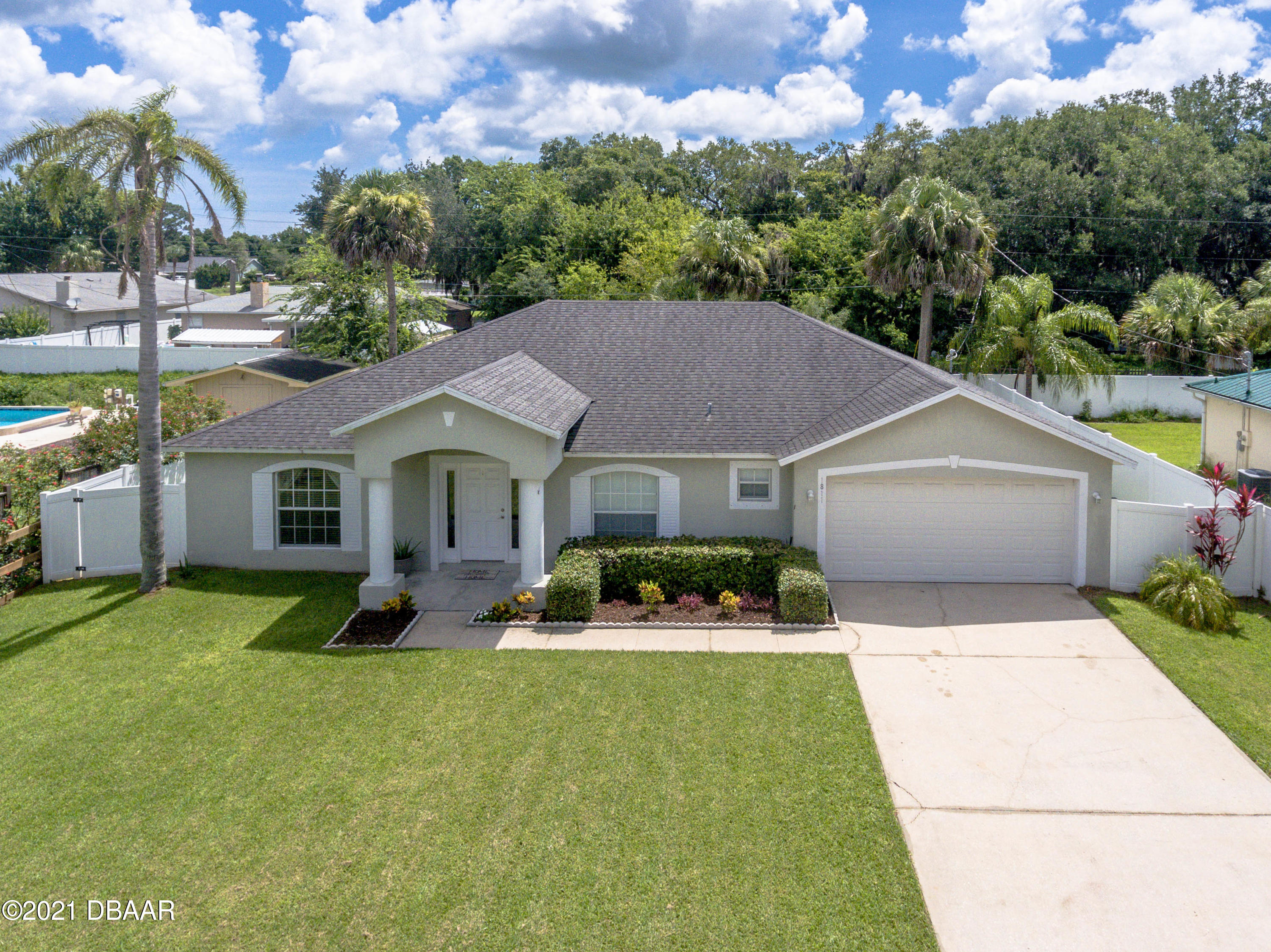 1811 Lime Tree Drive Edgewater, FL 32132 - Photo 1 of 35 a aerial view of a house with swimming pool and a yard