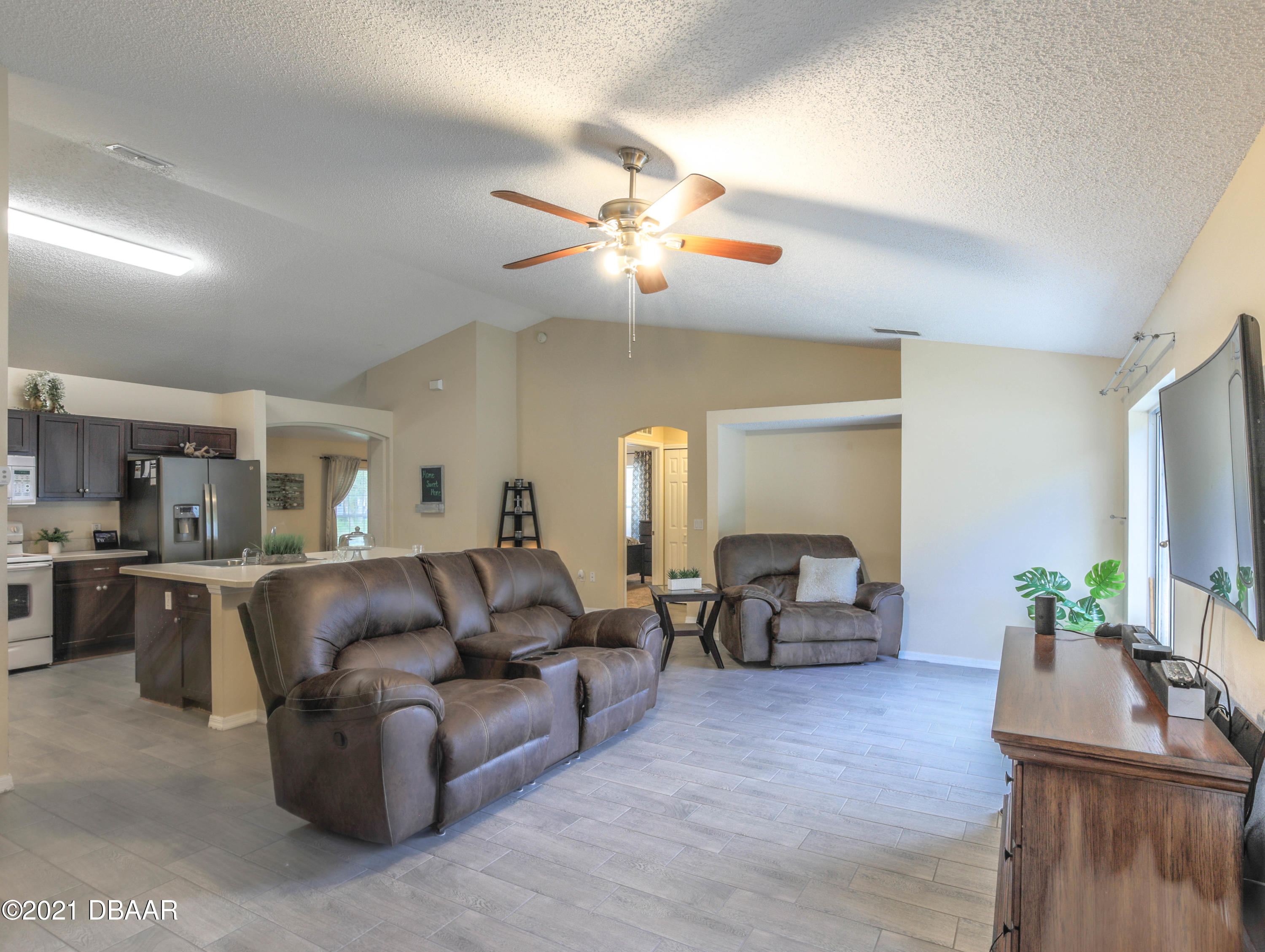 1811 Lime Tree Drive Edgewater, FL 32132 - Photo 12 of 35 a living room with furniture and a flat screen tv