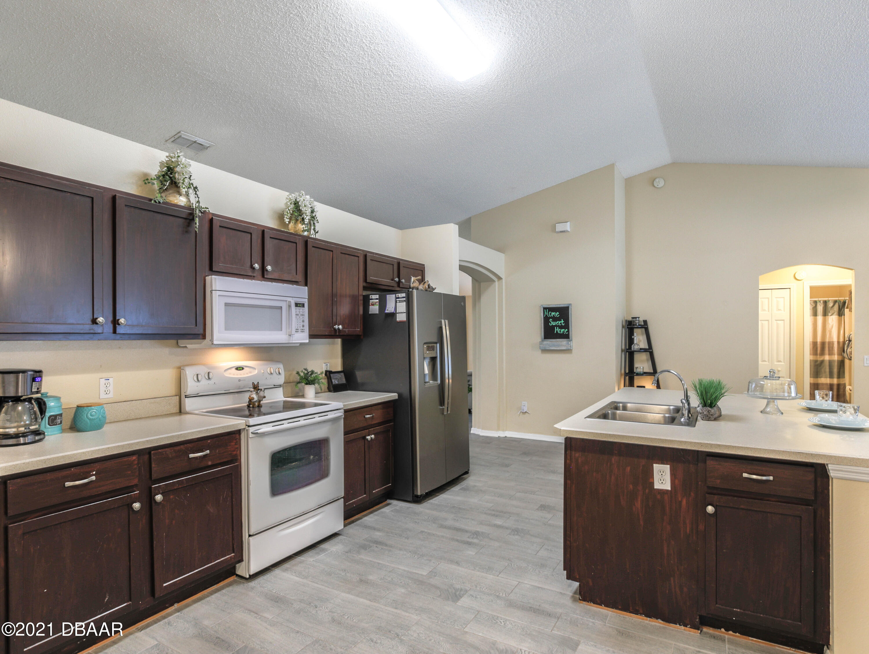 1811 Lime Tree Drive Edgewater, FL 32132 - Photo 13 of 35 a kitchen with a sink stove and refrigerator