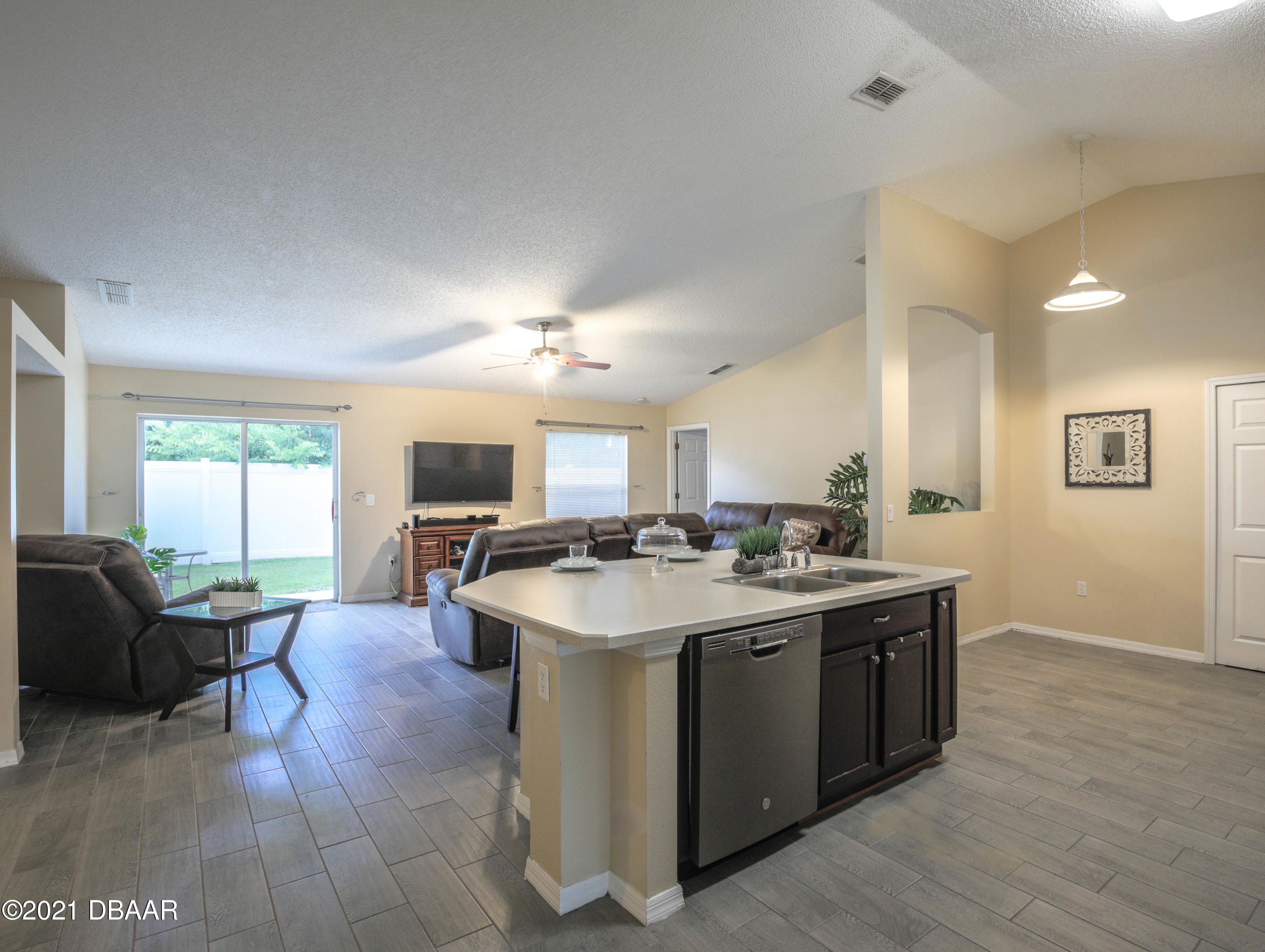 1811 Lime Tree Drive Edgewater, FL 32132 - Photo 14 of 35 a open kitchen with stainless steel appliances granite countertop a sink stove and refrigerator