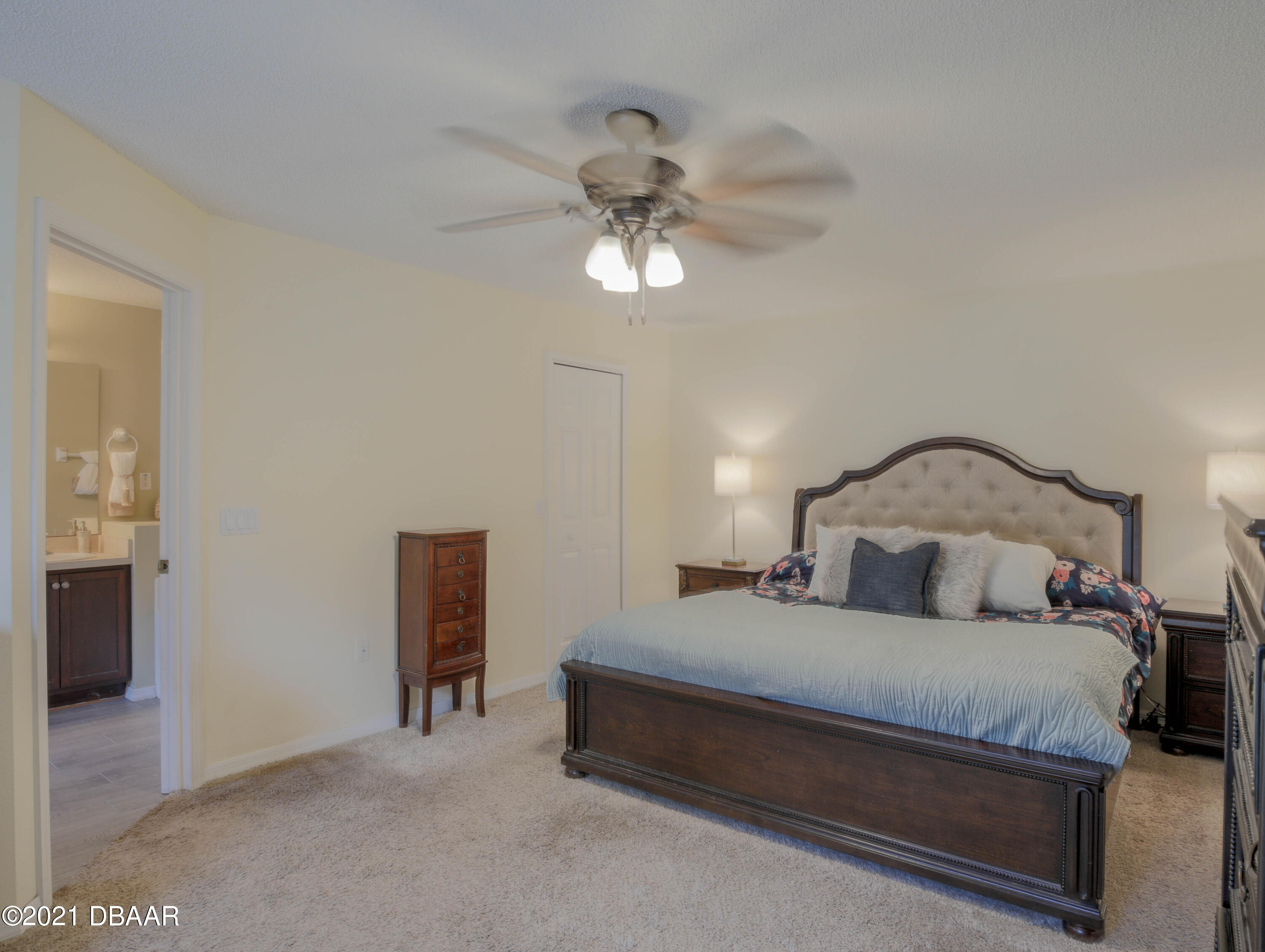 1811 Lime Tree Drive Edgewater, FL 32132 - Photo 16 of 35 a bedroom with a bed and a chandelier