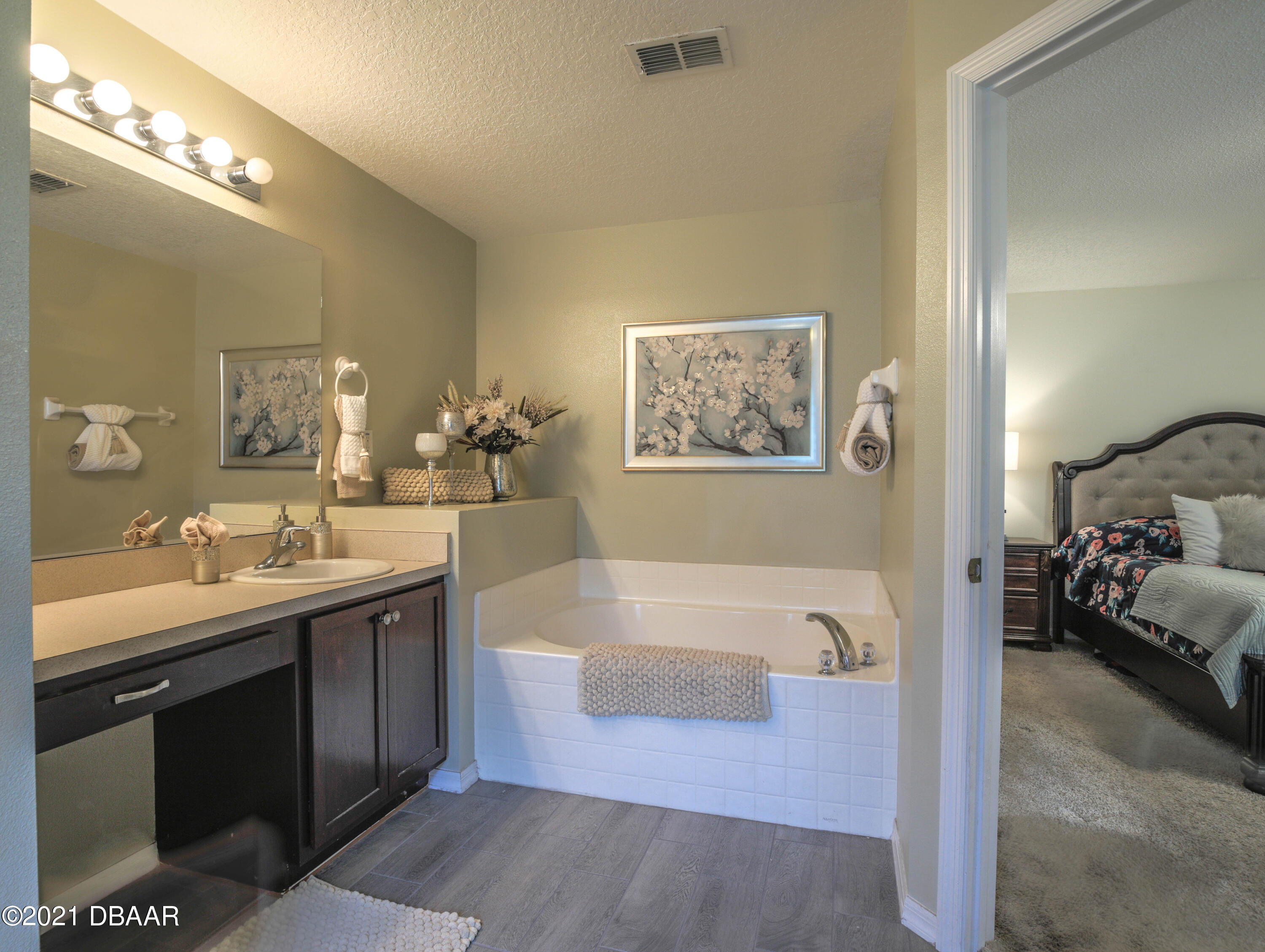 1811 Lime Tree Drive Edgewater, FL 32132 - Photo 18 of 35 a spacious bathroom with a tub sink and mirror