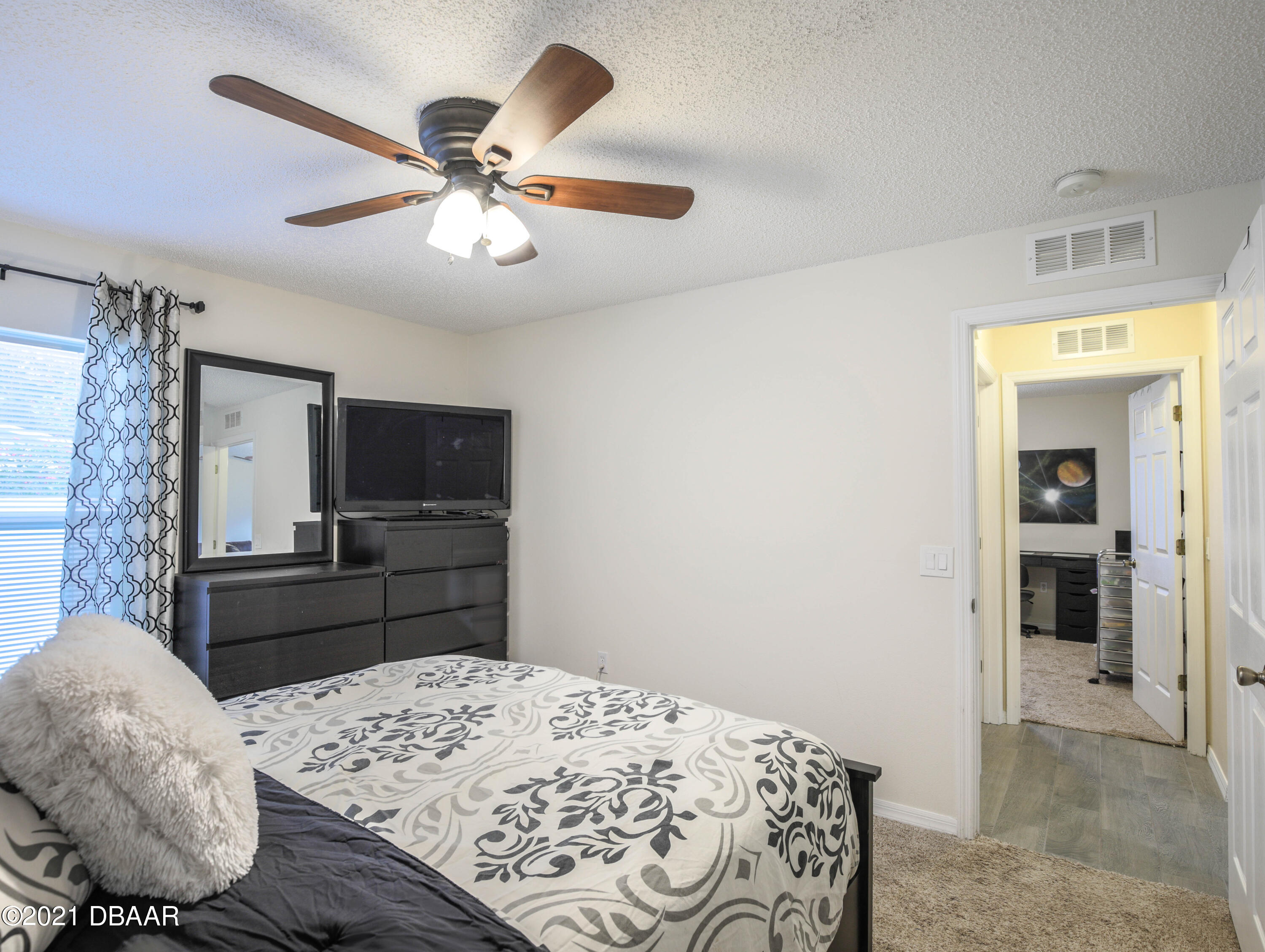1811 Lime Tree Drive Edgewater, FL 32132 - Photo 21 of 35 a bedroom with a bed and a television