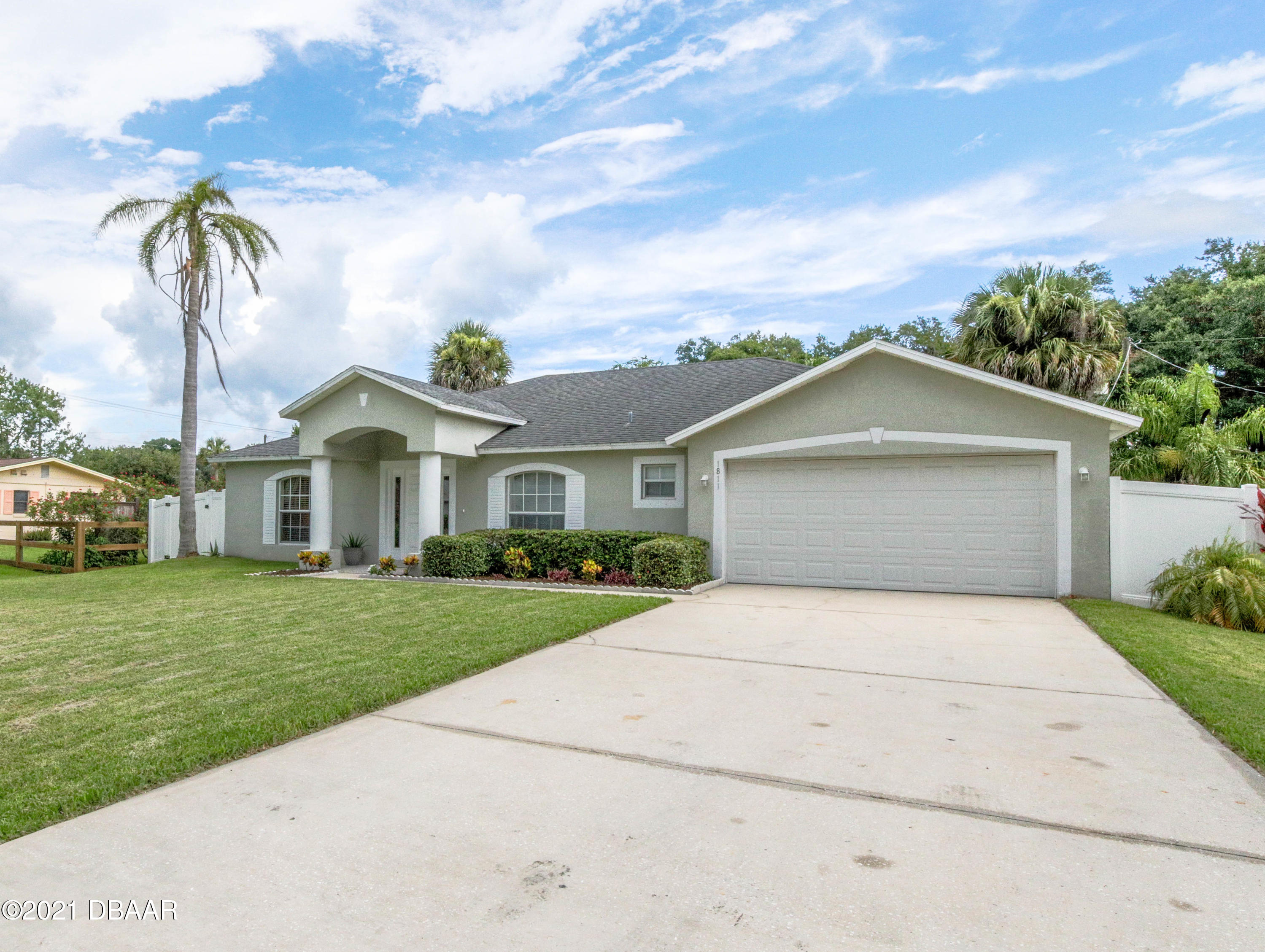 1811 Lime Tree Drive Edgewater, FL 32132 - Photo 28 of 35 a front view of a house with garden