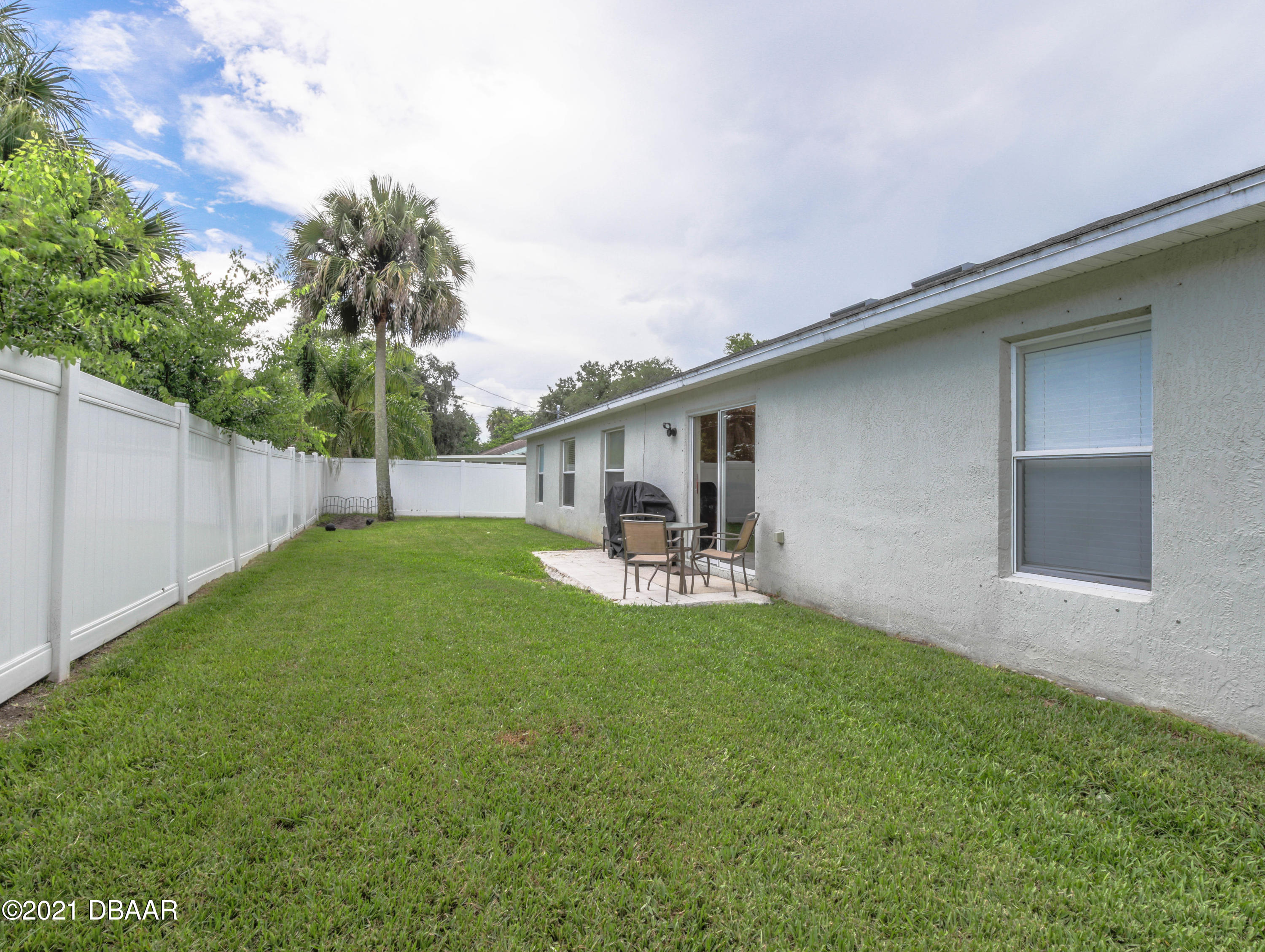 1811 Lime Tree Drive Edgewater, FL 32132 - Photo 29 of 35 a view of a backyard with table and chairs and plants