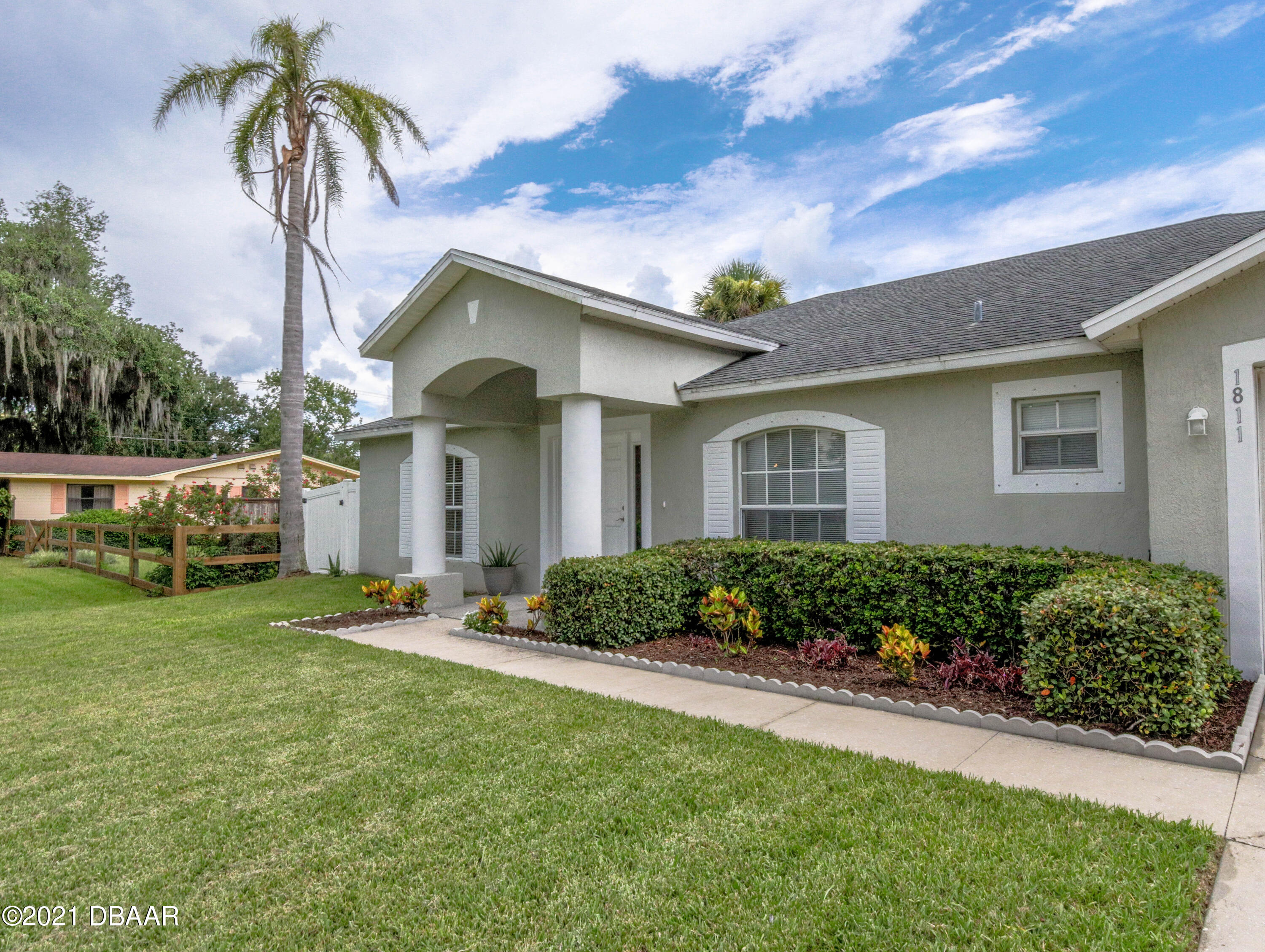 1811 Lime Tree Drive Edgewater, FL 32132 - Photo 3 of 35 a front view of a house with a garden