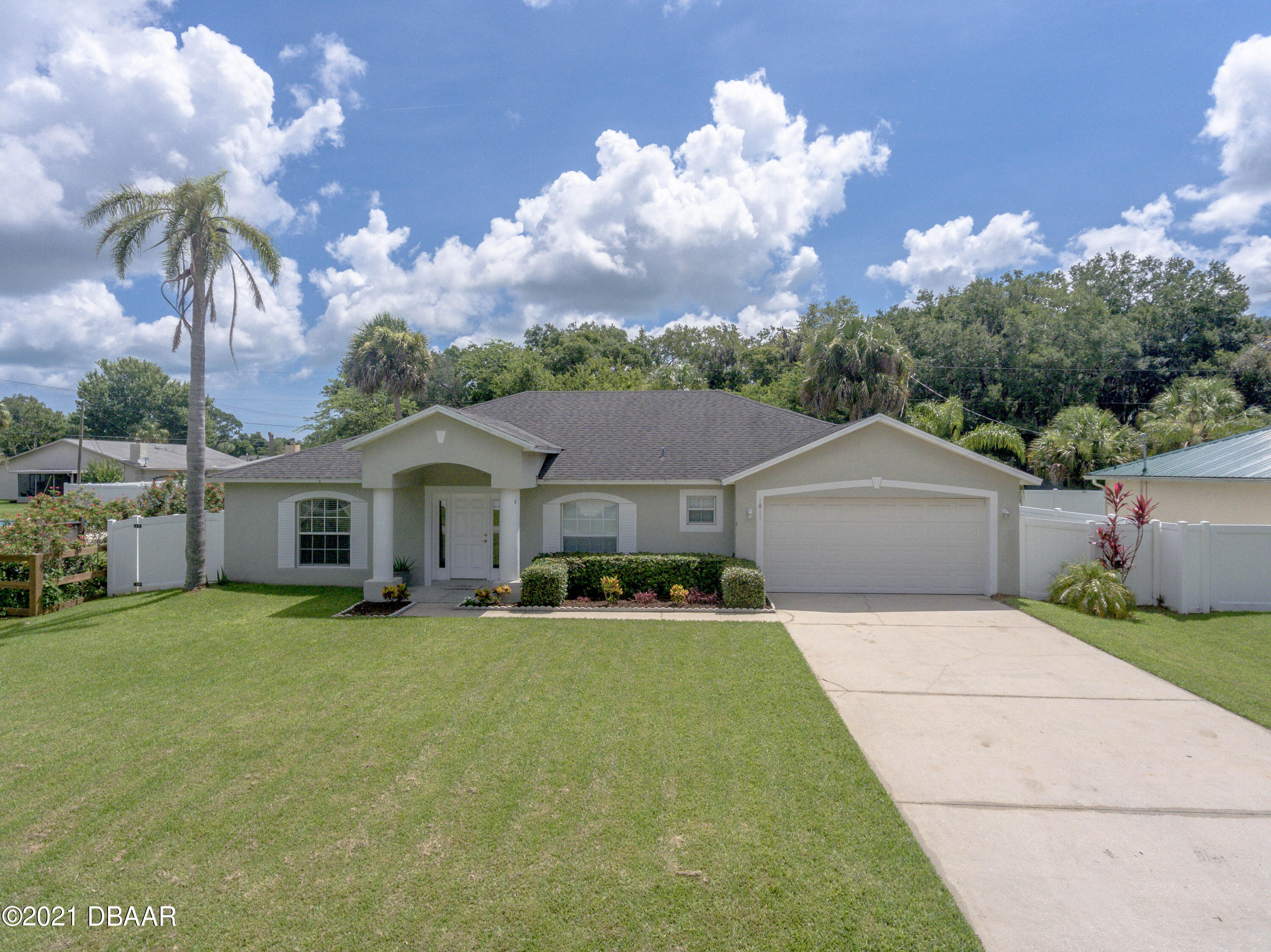 1811 Lime Tree Drive Edgewater, FL 32132 - Photo 32 of 35 a front view of a house with a yard and garage