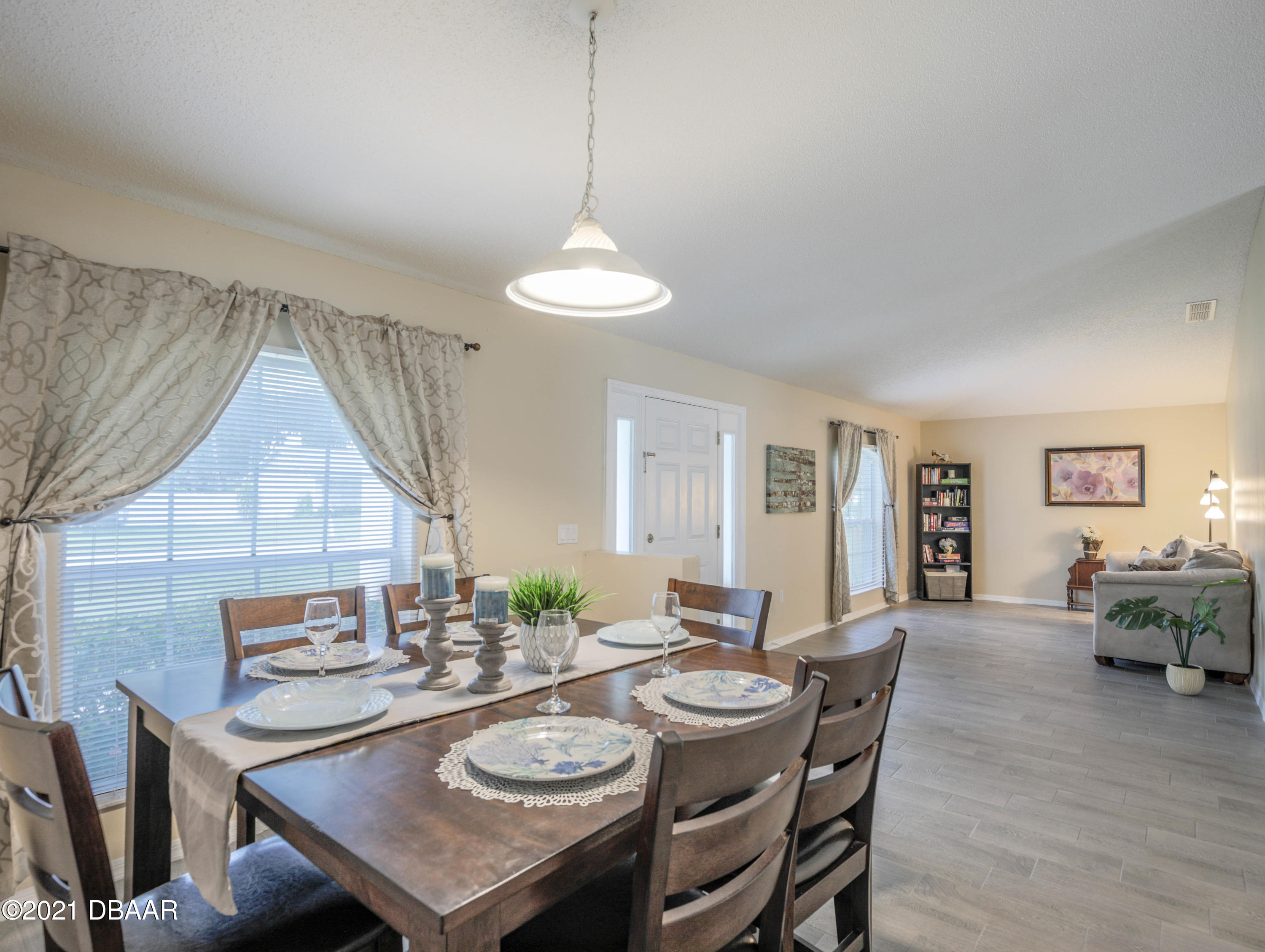 1811 Lime Tree Drive Edgewater, FL 32132 - Photo 4 of 35 a view of a dining room with furniture window and wooden floor