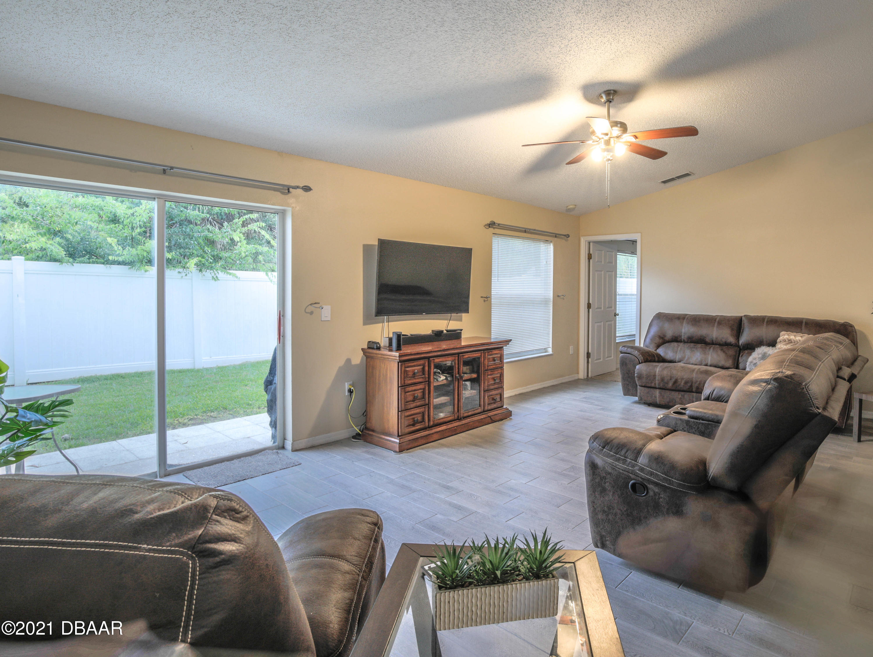1811 Lime Tree Drive Edgewater, FL 32132 - Photo 6 of 35 a living room with furniture and a flat screen tv