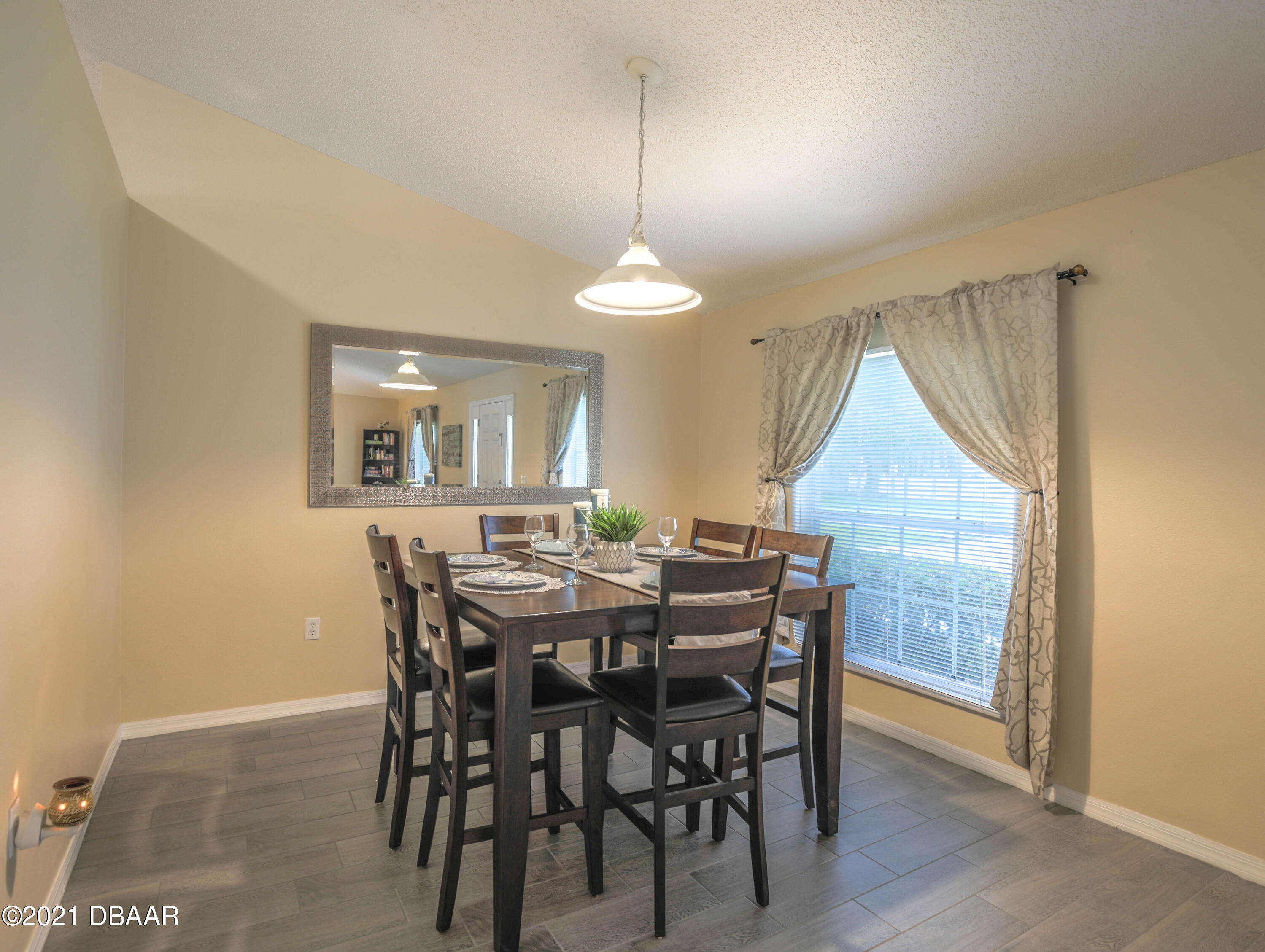 1811 Lime Tree Drive Edgewater, FL 32132 - Photo 8 of 35 a dining room with furniture a chandelier and window