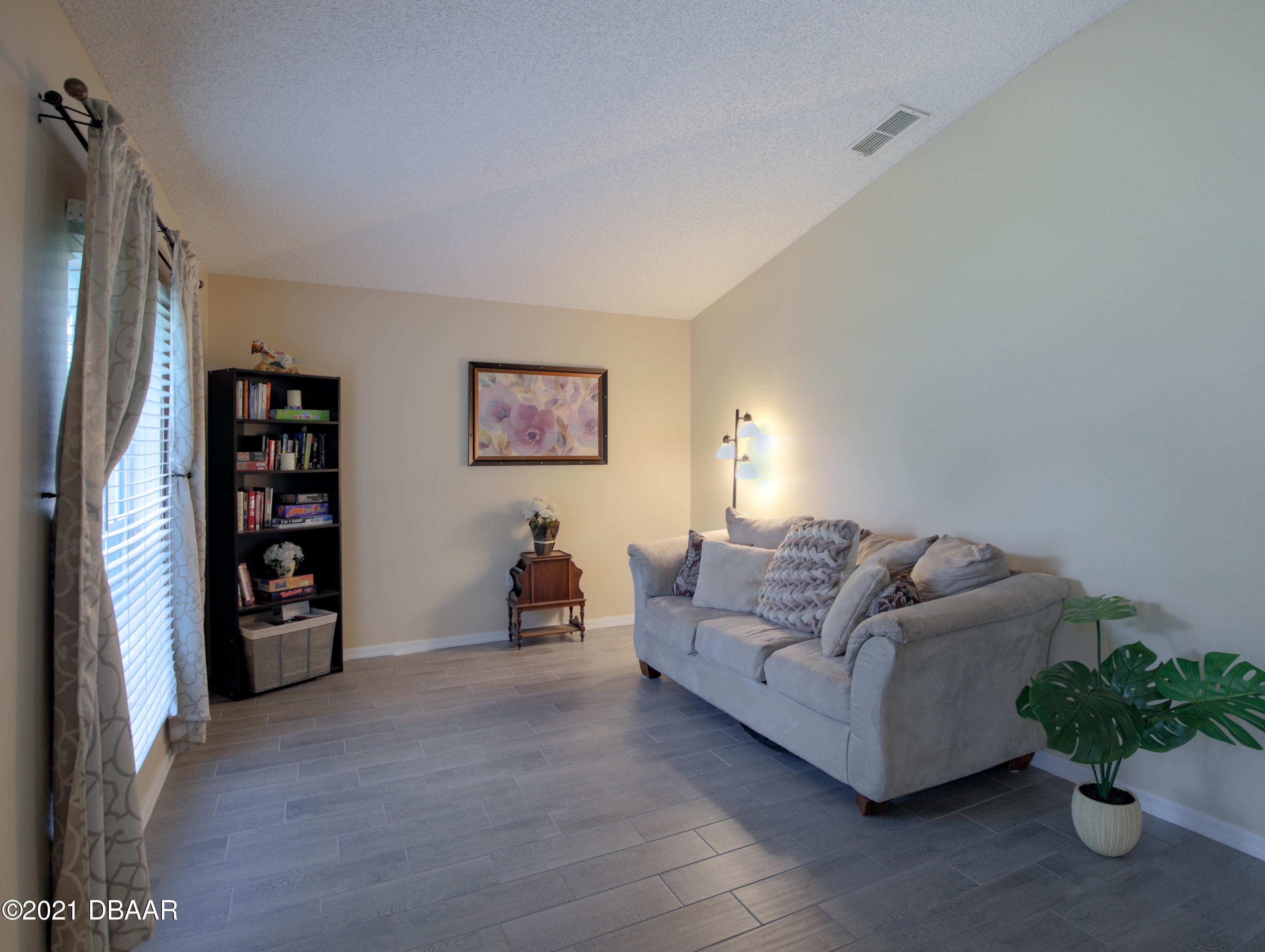 1811 Lime Tree Drive Edgewater, FL 32132 - Photo 9 of 35 a living room with furniture and a potted plant