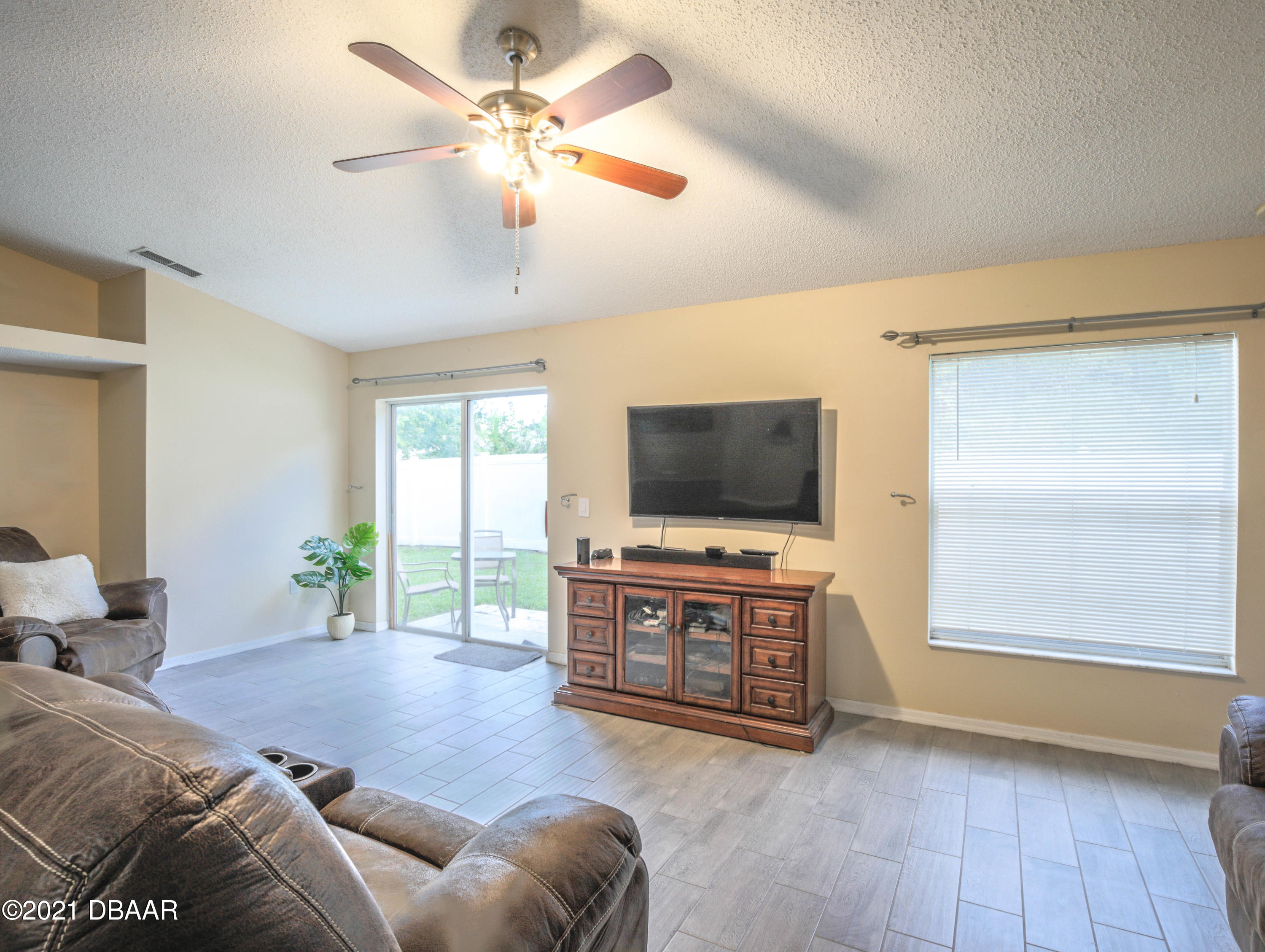 1811 Lime Tree Drive Edgewater, FL 32132 - Photo 10 of 35 a living room with furniture and a flat screen tv