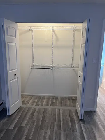 a view of a small space with wooden floor and white walls