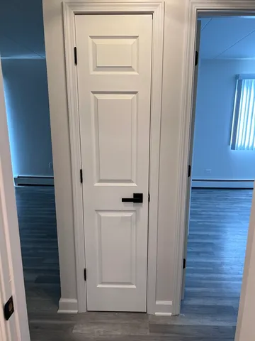 a view of a hallway with wooden floor