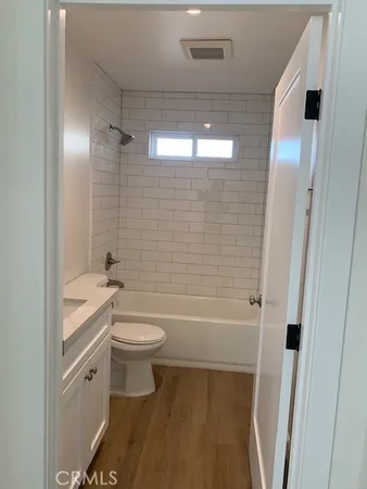 a bathroom with a toilet a sink and bathtub