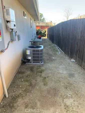a view of a backyard with wooden fence