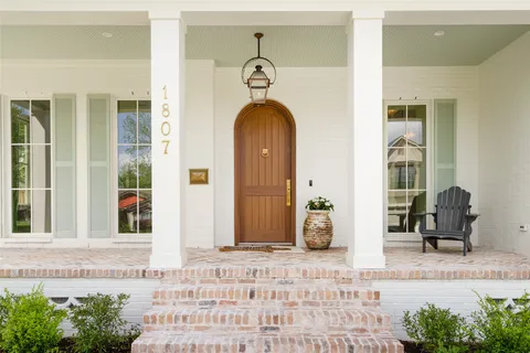 a front view of a house with outdoor seating