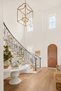 a view of a room with wooden floor and windows