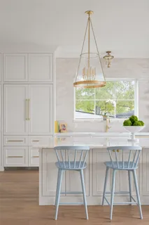 a kitchen with a table chairs and a wooden floor