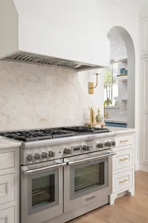 a stove top oven sitting inside of a kitchen
