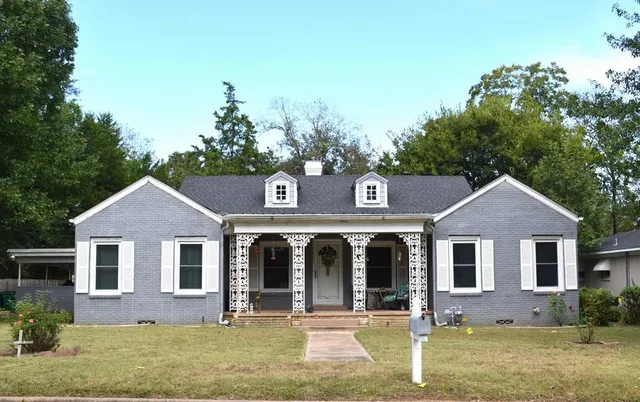 a front view of a house with garden
