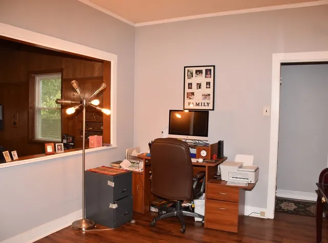 a view of workspace with wooden floor windows