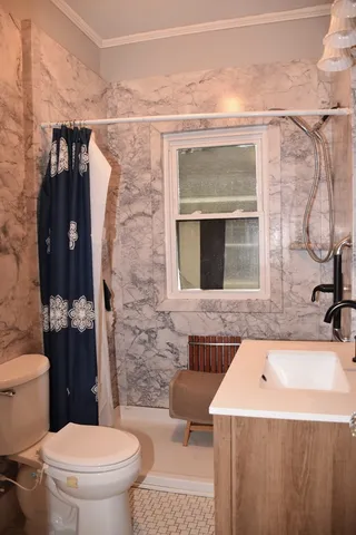 a bathroom with a sink toilet and shower