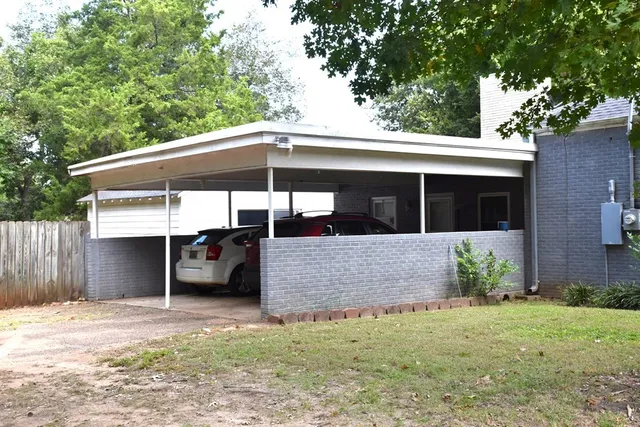 a view of house with outdoor seating and yard