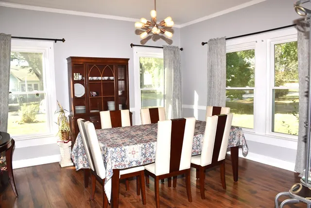 a view of a dining room with furniture window and wooden floor