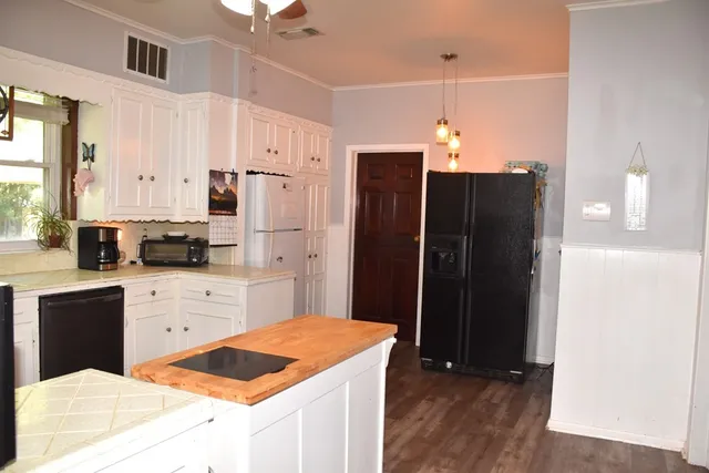 a kitchen with stainless steel appliances a refrigerator sink and cabinets
