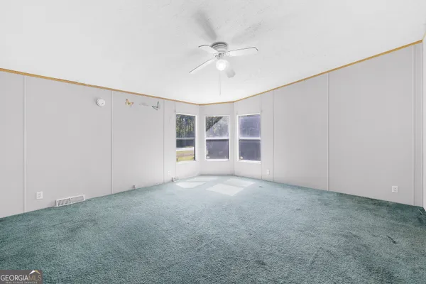an empty room with windows and closet