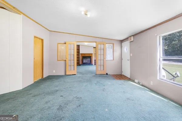 an empty room with windows and closet