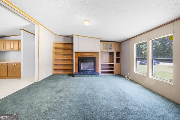 an empty room with furniture and a window