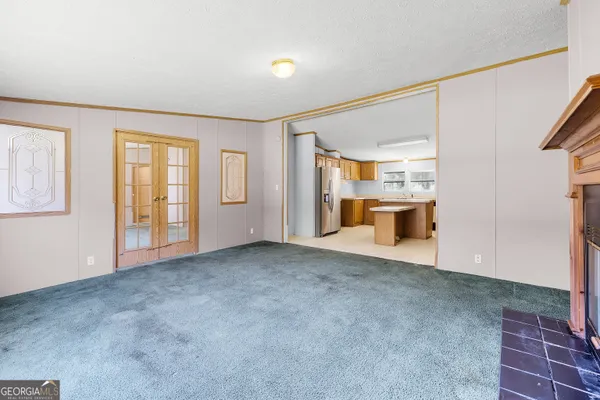 an empty room with windows and cabinet