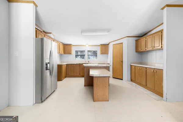 a kitchen with stainless steel appliances refrigerator sink and cabinets