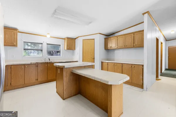 a kitchen with stainless steel appliances granite countertop a sink a stove and a refrigerator