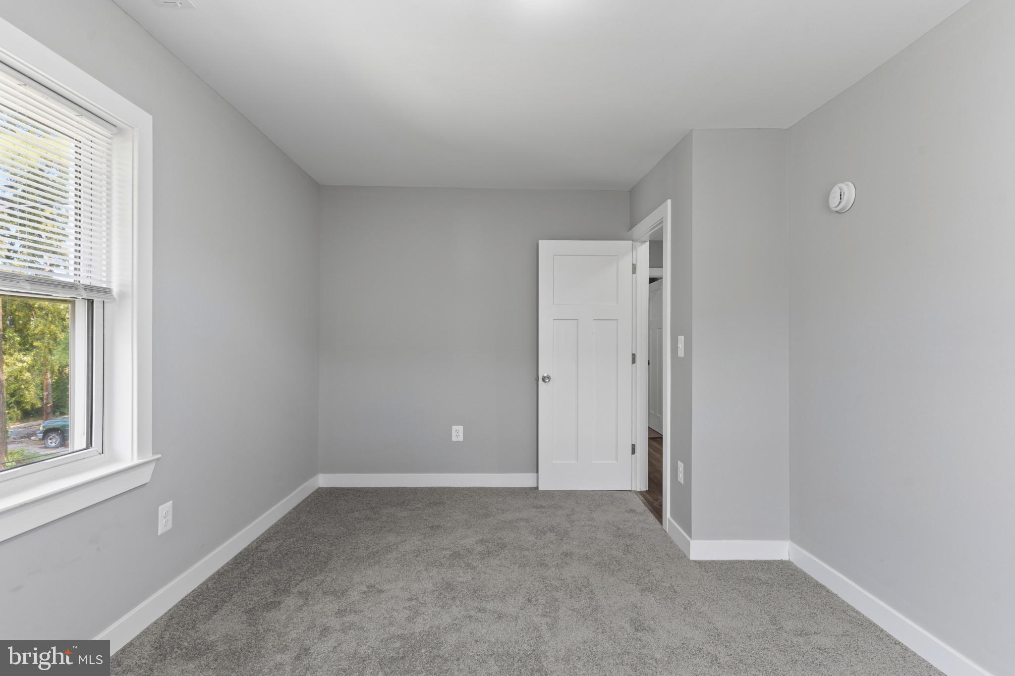 5728 Clover Road Baltimore, MD 21215 - Photo 24 of 40 an empty room with windows and closet