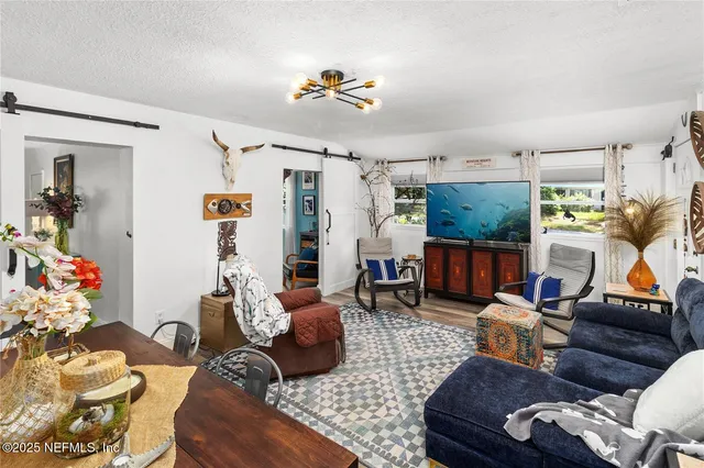 a bedroom with bed and painting on the wall