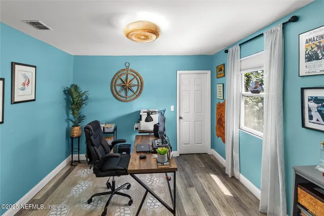 a bedroom with a bed a mirror and desk