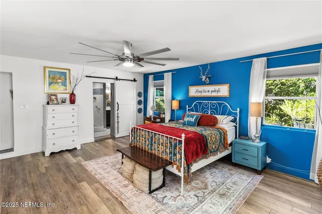 a bedroom with furniture and a window