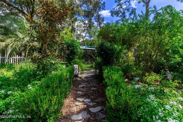 a view of a house with a flower garden