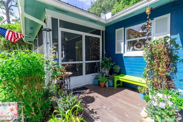 a view of a porch with dining table and chairs