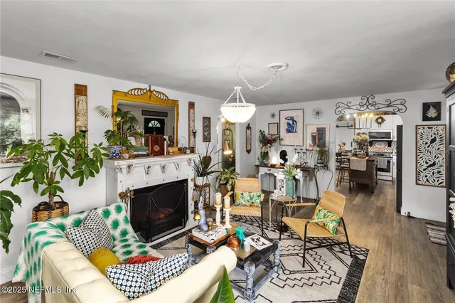 a living room filled with furniture and a potted plant