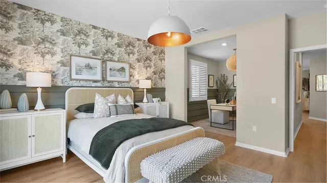 a bedroom with a bed and a chandelier