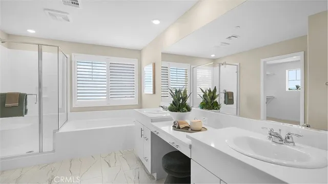 a bathroom with a sink a tub and a mirror